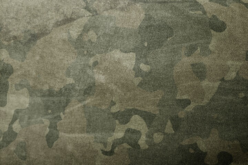 Texture of military dirty camouflage fabric. Combat protective camouflage for background
