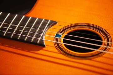 Fototapeta premium Classical Spanish flamenco guitar close up, dramatically lit isolated on black background with copy space.