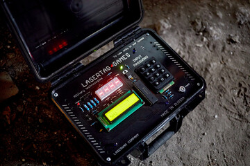 Open time-bomb case for playing lasertag games outdoor on snowy ground.