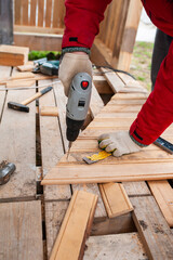 Worker sawing boards for construction - 762274847