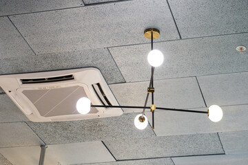 Designer LED lamp on the office ceiling. Interior lighting. Decorative elements on the ceiling.