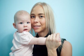 Happy young mother with baby in her arms.