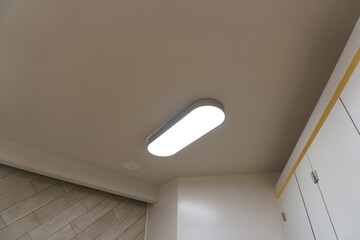 Designer LED lamp on the office ceiling. Interior lighting. Decorative elements on the ceiling.