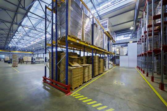 Warehouse with packages of cardboard blanks at factory.