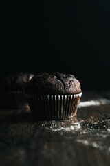 Chocolate muffins in a moody dark kitchen