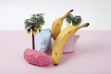  composition and metaphor for an island with palm trees, composed of ripe bananas and brightly painted pebbles