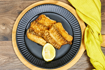 grilled Ray or skate filet decorated with slice of lemon 
