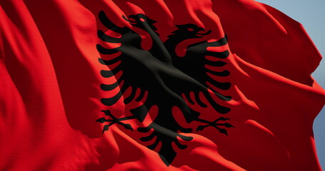 Close-up of the national flag of the republic of albania flutters in the wind on a sunny day