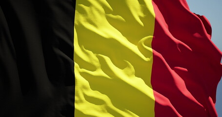 Close-up of the national flag of the kingdom of belgium flutters in the wind on a sunny day