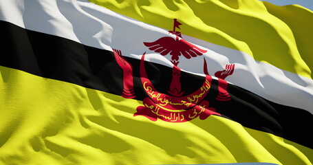 The national flag of the State of Brunei flutters in the wind on a sunny day