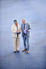 Professional, businesspeople talking and documents, signing for work with coworkers. Mature, business man and woman discussing information, lawyers for corporate company staff standing together