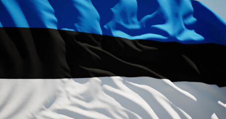 Close-up of the national flag of Estonia flutters in the wind on a sunny day