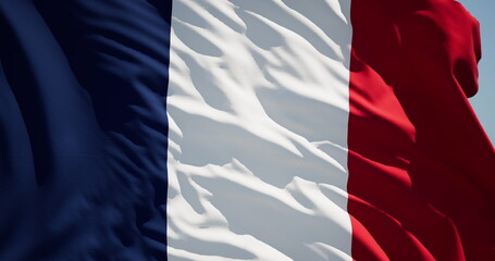 Close-up of the national flag of France flutters in the wind on a sunny day