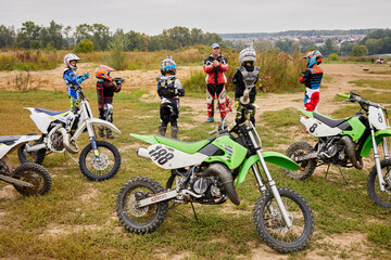 Trainer works with children motorcross team before main training outdoor.