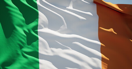 Close-up of the national flag of Ireland flutters in the wind on a sunny day