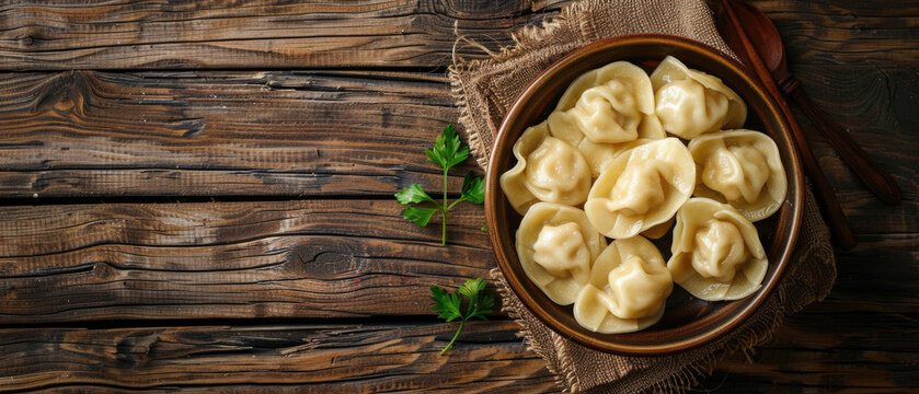 boiled dumplings in a plate on a wooden table. Copy space for text