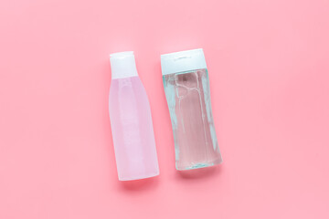 facial tonic and lotion for face care on pink background top view mockup