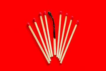 Matches for danger concept on red background top view
