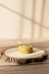 Handmade beautiful decorative candle of bee wax on pastel beige background.