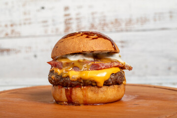 Hamburgers with cheddar cheese and special sauce on a wooden background