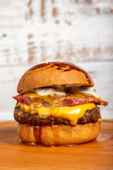 Hamburgers with cheddar cheese and special sauce on a wooden background. Close up