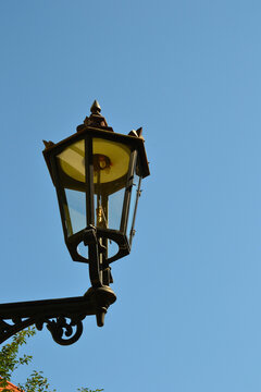 Gas street lamp, lantern. The Cathedral Island (polish: Ostrow Tumski) in Wroclaw, Poland. One of the few remaining places in Europe where a lamplighter lights the gas street lamps every evening
