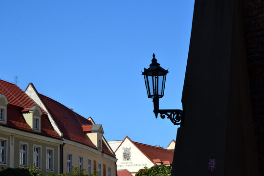Gas street lamp, lantern. The Cathedral Island (polish: Ostrow Tumski) in Wroclaw, Poland. One of the few remaining places in Europe where a lamplighter lights the gas street lamps every evening
