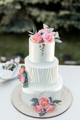 beautiful wedding cake near the wedding arch in the evening