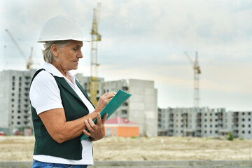 Portrait of an elderly woman on a construction site