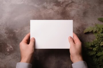 The man is holding a white envelope mockup in his hands. Beautiful business layout.