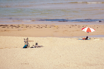 Bicycle and umbrella on the beach