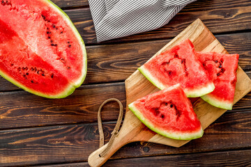 Slices of watermelon on wooden background top view