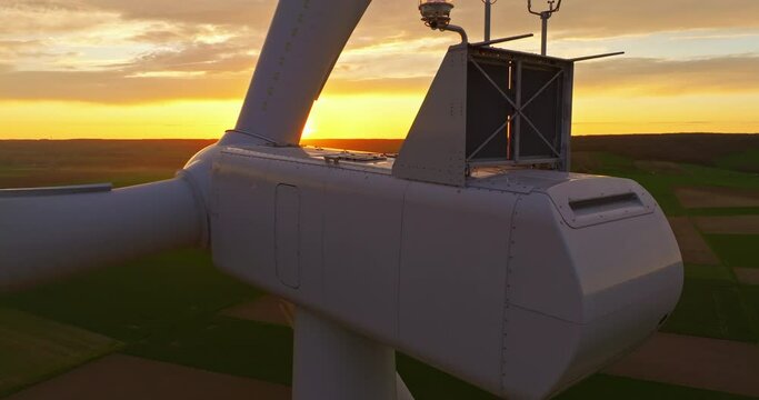 Alternative energy. Aerial view of windmills farm. Power energy production in USA. Landscape with wind turbines. Large wind turbines with blades in field aerial view bright orange sunset