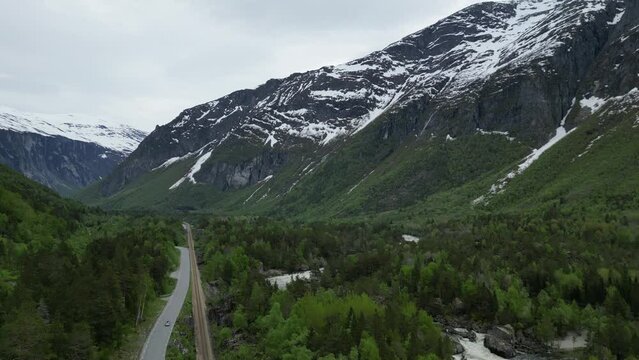 Rauma River in Romsdalen, Rauma Norway, with massive boulders, surrounded by evergreen trees and sno