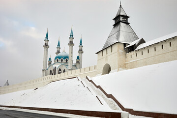 Mosque of Kazan Kul Sharif behind Kremlin wall with tower on winter day.