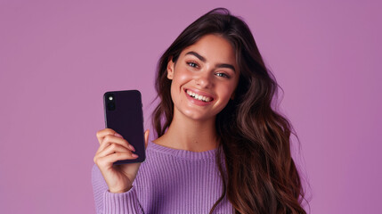 Fototapeta premium Happy Woman Displaying Mobile Screen with Purple Background 