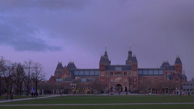 Netherlands, March 28 2023: Amsterdam at summer night. Famous national Rijks museum general view at dusk 4k