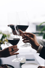 Blonde women with wine glasses. Group of friends in the elegant wear have luxury dinner.