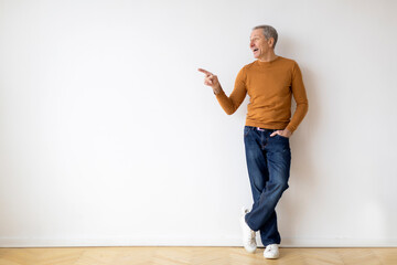 Man in orange sweater pointing to side