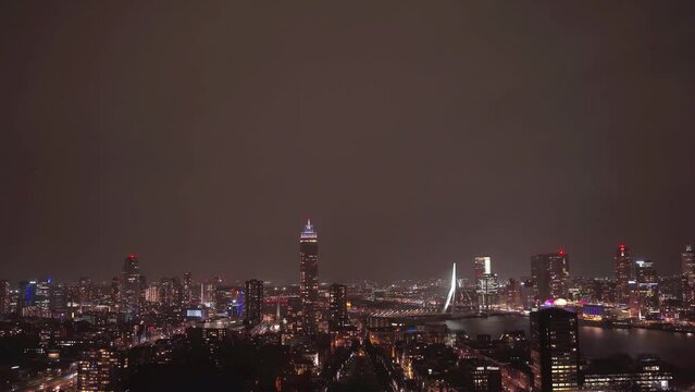 Rotterdam skyline with Erasmus bridge at twilight as seen from the Euromast tower, The Netherlands. Night urban landscape with tall buildings of a large European port city