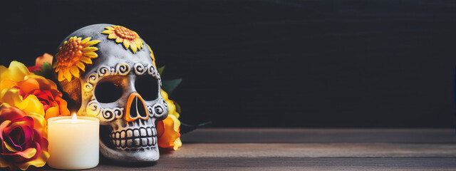 Still life of a decorated skull, candle and flowers on a wooden table with a dark background. - obrazy, fototapety, plakaty