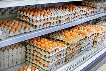 farm brown chicken eggs in cardboard containers on the store counter. Approaching Easter. Crisis...