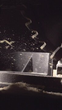 Witness the precision of craftsmanship with this 4K vertical slow-motion clip featuring a circular saw cutting through wood