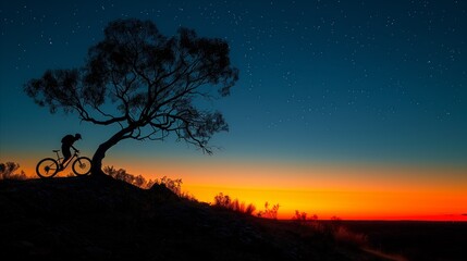Fototapeta na wymiar Silhouetted cyclist under a starry sky at twilight