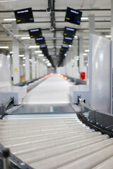 Big empty modern workshop with conveyor, many displays in warehouse