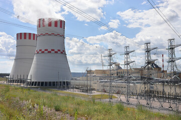 Smoking pipes, poles with wires of atomic thermal power plant at summer