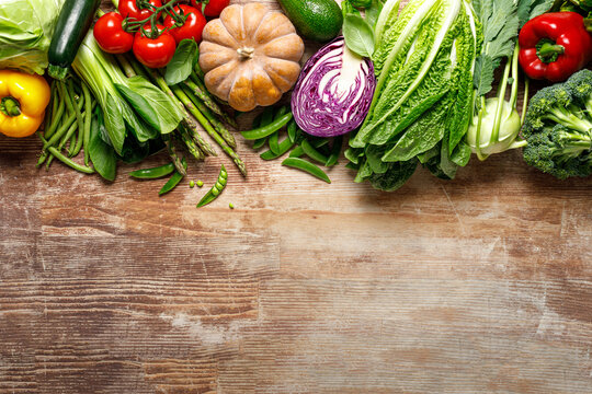 Vegetables background. Various vegetables on kitchen table. Clean eating, healthy food concept, flat lay, top down view
