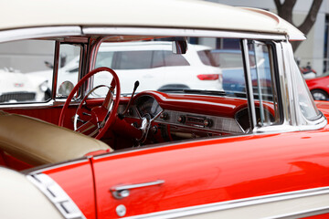 Fototapeta premium A very luxurious red and white car was parked on road