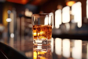Foto auf Alu-Dibond A glass of whiskey sitting on top of a bar. Ideal for bar and beverage concepts © Fotograf