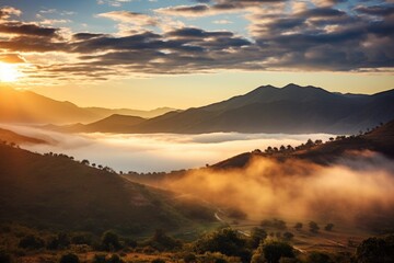 Scenic view of sun setting over valley with mountains in background. Perfect for nature and landscape concepts